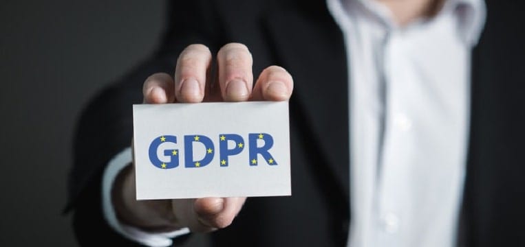 Person holding an index card that says "GDPR," which stands for General Data Protection Regulation